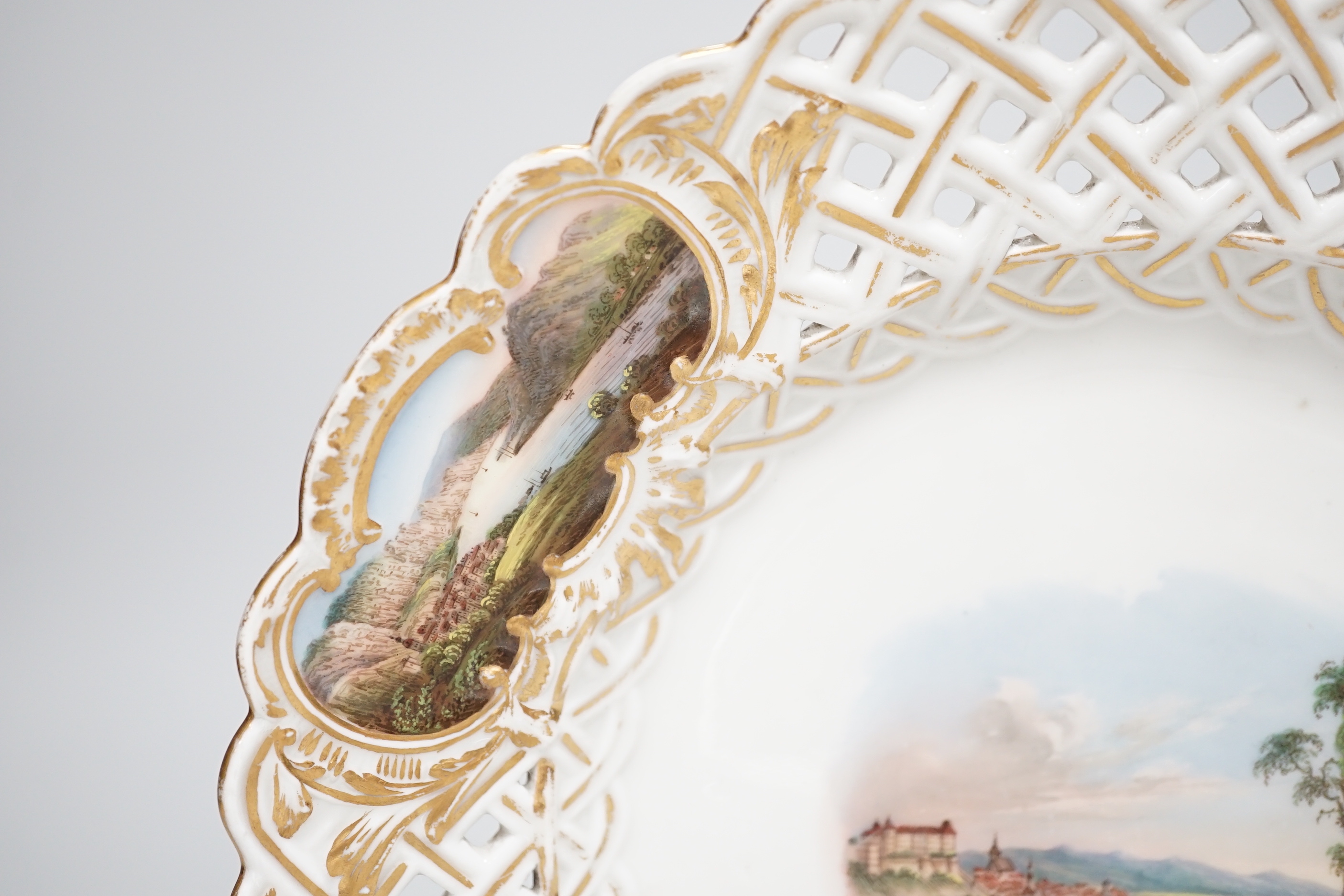 A Meissen topographical reticulated plate, 19th century, painted with named views; Pirna, Wehlstadtel, Weefenstein and Die Lochmukle, 24cm